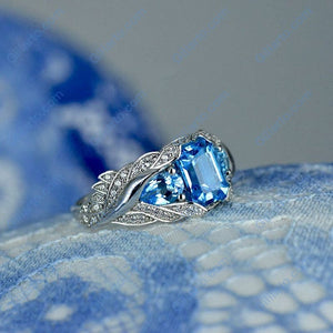3.0 Carat Blue Topaz 8x6mm Emerald Cut Center Stone and two Pear 6x4mm 2x0.5 Carat Wing Ring with 10K white Gold ring size 9