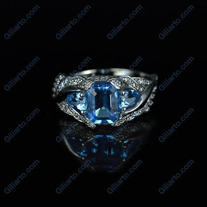 3.0 Carat Blue Topaz 8x6mm Emerald Cut Center Stone and two Pear 6x4mm 2x0.5 Carat Wing Ring with 10K white Gold ring size 9
